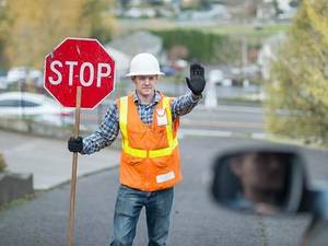 construction worker holding stop sign